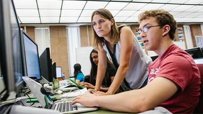 Julie Medero and student working on a computer. 